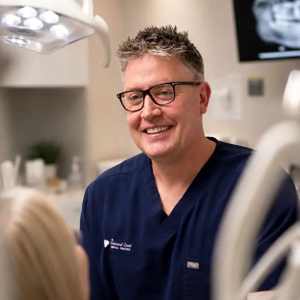 A dentist smiling in the surgery