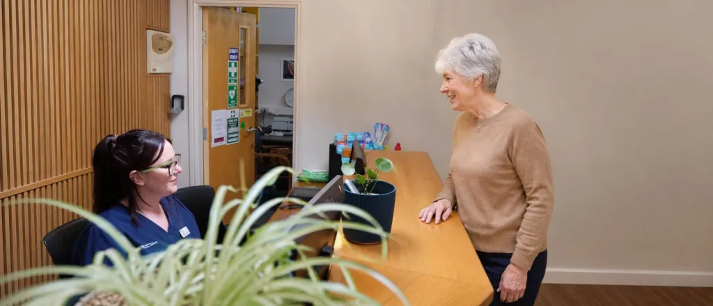A patient arriving at the Diamond Court reception desk