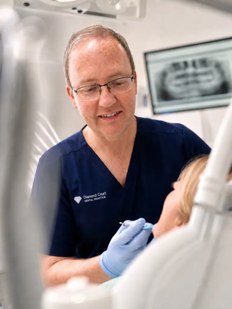 A dentist discussing an X-ray with a patient
