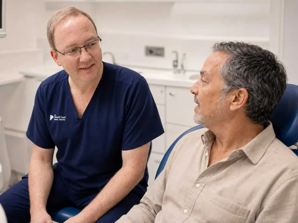 A dentist chatting with a patient chairside