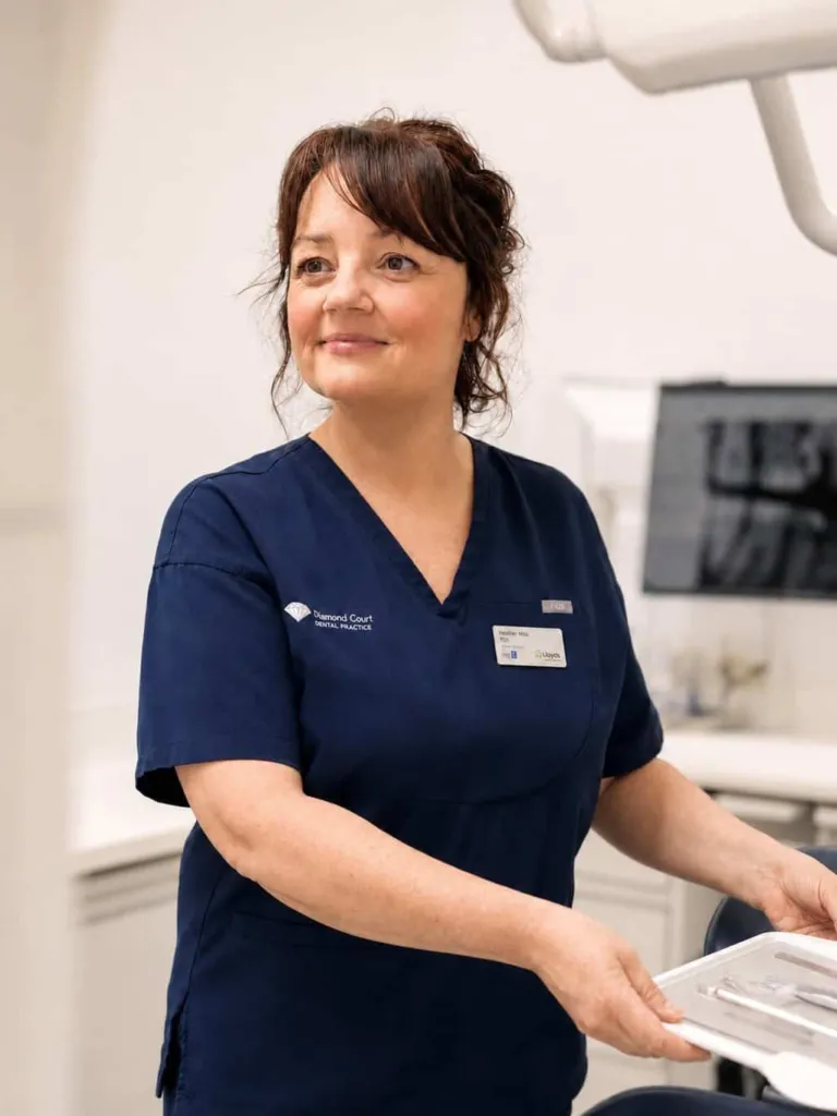 A dental nurse bringing a patient through