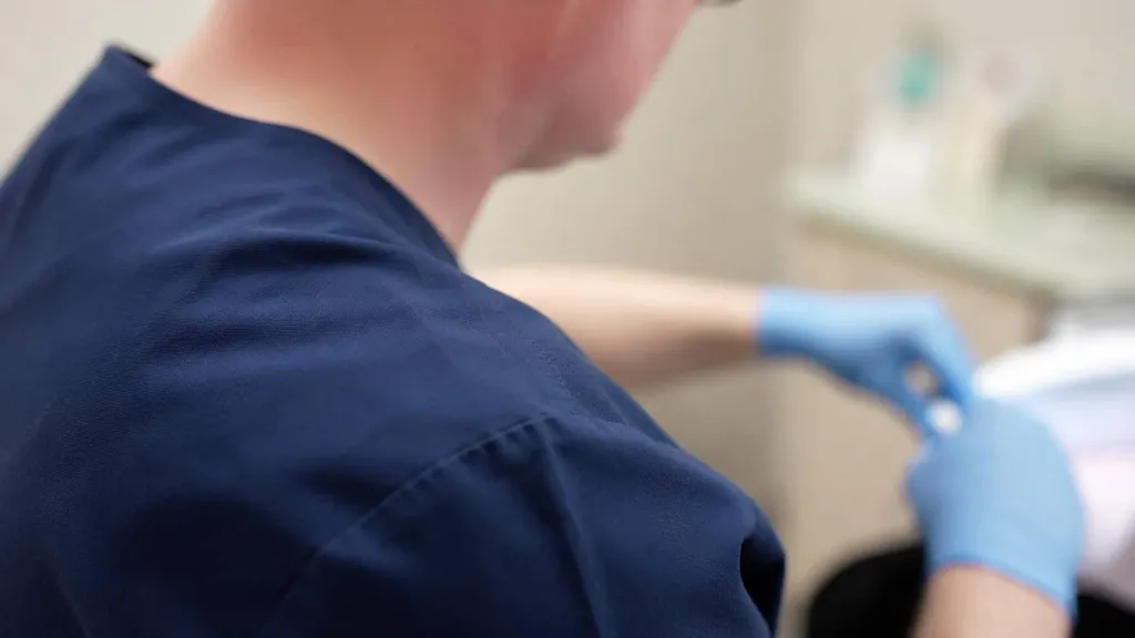 Gloved hands, over the shoulder