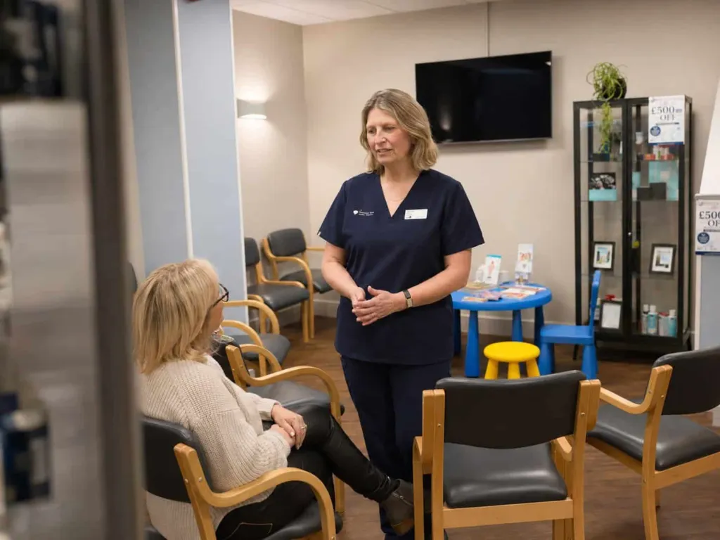 A dental nurse smiling in the waiting room