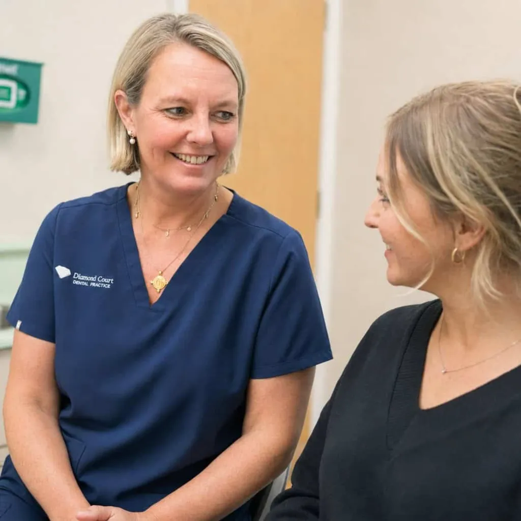 A nurse talking an older patient through their notes